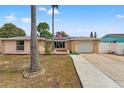 Charming single-story home with a well-maintained lawn and an American flag displayed out front at 7631 Ironbark Dr, Port Richey, FL 34668