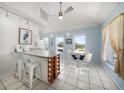 Bright kitchen featuring modern appliances, breakfast bar, and an adjacent dining area at 960 Gulf Blvd # 5, Indian Rocks Beach, FL 33785