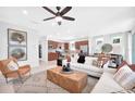 Bright and inviting living room featuring stylish furnishings and an open floor plan, seamlessly connecting to the kitchen at 11444 Shoreline Trl, Parrish, FL 34219