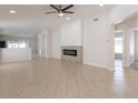Bright, open-concept living room with tile flooring and a stylish fireplace at 11448 Bay Gardens Loop, Riverview, FL 33569