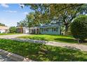 Charming single-story home showcasing manicured lawn and sidewalk at 1208 E Crenshaw St, Tampa, FL 33604