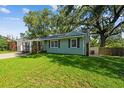 Lovely home featuring well-maintained lawn, and mature trees at 1208 E Crenshaw St, Tampa, FL 33604