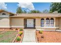 Close up of the front entrance showing the double doors, walkway, and lovely landscaping at 13167 Roseanna Dr, Spring Hill, FL 34609