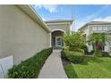 Inviting front entrance with a paved walkway and well-maintained landscaping at 13524 Circa Crossing Dr, Lithia, FL 33547