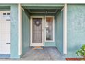 Close-up of a home's front door, showing a wreath and the adjacent sidelight window and white doorframe at 17701 Sunrise Dr, Lutz, FL 33549