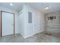 A room with white walls, closet, an electrical panel, and a mounted TV bracket at 2001 E 2Nd Ave # 12, Tampa, FL 33605