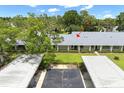 An overhead angle of the condo with carports and a well-maintained green lawn at 2557 Laurelwood Dr # 10D, Clearwater, FL 33763