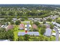 A captivating aerial perspective showcases the condo nestled amidst verdant trees near a tranquil lake at 2557 Laurelwood Dr # 10D, Clearwater, FL 33763