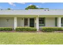 Close up of condo exterior featuring a well-kept lawn and building number at 2557 Laurelwood Dr # 10D, Clearwater, FL 33763