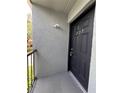 Front door of unit 203, next to a stucco wall, and protected by a small covered porch at 2850 Somerset Park Dr # 203, Tampa, FL 33613