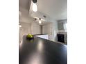 An open kitchen with white appliances and cabinets, a black counter top, and recessed lighting at 2850 Somerset Park Dr # 203, Tampa, FL 33613