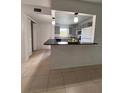 Kitchen featuring tan floors, a breakfast bar, updated appliances, and gray colored cabinets at 2850 Somerset Park Dr # 203, Tampa, FL 33613