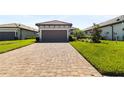 Charming single-Gathering home featuring a tile roof, attached garage and manicured landscaping at 3312 Francoa Dr, Odessa, FL 33556