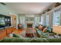 Inviting living room with fireplace, hardwood floors, large windows and shutters at 3516 W Santiago St, Tampa, FL 33629