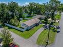 Expansive aerial view showcases the home's spacious lot, mature trees, and well-maintained landscaping at 37153 Mcminn Ave, Dade City, FL 33525