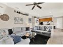 Spacious living room featuring two plush grey couches, sleek ceiling fan, and unique decor at 406 Laguna Mill Dr, Ruskin, FL 33570
