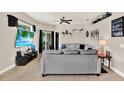 Comfortable living room with tile floor, a large grey sectional, and sliding glass doors at 406 Laguna Mill Dr, Ruskin, FL 33570