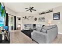 Inviting living room with tile floors, a grey sectional, and stylish decorations at 406 Laguna Mill Dr, Ruskin, FL 33570