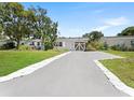 Long driveway leading up to a charming one-story home with an inviting exterior at 5514 7Th N Ave, St Petersburg, FL 33710