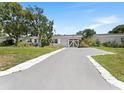 A single-story home featuring a new concrete driveway and well-kept landscaping at 5514 7Th N Ave, St Petersburg, FL 33710