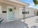Close-up of front entrance featuring decorative door with floral wreath and modern fixtures at 5514 7Th N Ave, St Petersburg, FL 33710