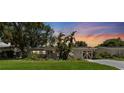 Charming one-story home with a well-manicured lawn during an evening sunset at 5514 7Th N Ave, St Petersburg, FL 33710