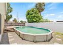 Backyard features a private above-ground pool, perfect for relaxation and outdoor enjoyment, nestled in a fenced yard at 6012 Flora Ter, Apollo Beach, FL 33572