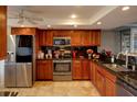 Updated kitchen featuring granite countertops, stainless steel appliances, and wood cabinets at 650 Island Way # 606, Clearwater Beach, FL 33767