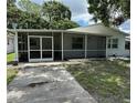 Home exterior featuring a screened porch and walkway leading to the front door at 7651 46Th N Way, Pinellas Park, FL 33781
