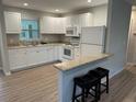 Well-lit kitchen with white cabinets, countertops, and modern appliances at 7651 46Th N Way, Pinellas Park, FL 33781
