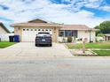 Charming single-story home featuring a well-manicured lawn and an attached two car garage at 8110 Damara Dr, New Port Richey, FL 34653