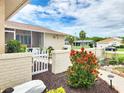 Home featuring a beautifully landscaped front yard with colorful flowers, white picket fence and stone walkway at 8110 Damara Dr, New Port Richey, FL 34653