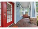 Charming front porch with a porch swing and brick flooring enhances the exterior at 10015 Brompton Dr, Tampa, FL 33626