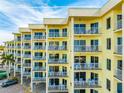 Balconies adorn a multi-story building with outdoor seating, offering scenic views and modern comfort at 12000 Gulf Blvd # 506N, Treasure Island, FL 33706