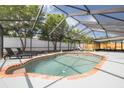 Large screened-in pool area with brick trim and ample seating, perfect for entertaining at 12092 97Th Ave, Seminole, FL 33772