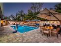 Relaxing backyard pool area with comfortable seating, perfect for entertaining guests on warm evenings at 1242 Whisper Dr, Largo, FL 33770