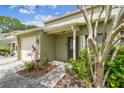 Welcoming townhouse entryway surrounded by lush plantings, offering a charming curb appeal at 1508 Adams E Cir, Largo, FL 33771