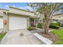 Attractive townhouse with an attached garage, well-maintained lawn, and inviting front entrance at 1508 Adams E Cir, Largo, FL 33771