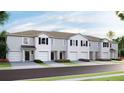 Charming townhomes featuring attached garages and beautifully landscaped front yards at 17465 Spanish Oak Loop, Land O Lakes, FL 34638