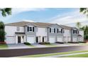 Charming townhomes featuring attached garages and beautifully landscaped front yards at 17465 Spanish Oak Loop, Land O Lakes, FL 34638