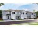 Charming townhomes featuring attached garages and beautifully landscaped front yards at 17465 Spanish Oak Loop, Land O Lakes, FL 34638