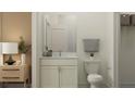 Bathroom with white cabinetry, marble countertops, decorative plant accents, and a modern mirror at 18137 Serene Lake Loop, Lutz, FL 33548