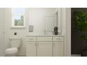Well-lit bathroom with white cabinetry, a marble countertop, decorative plant accents, and a large mirror at 18137 Serene Lake Loop, Lutz, FL 33548