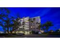 Exterior view of the well-maintained condo building featuring lush landscaping and ample parking at 2 Seaside Ln # 203, Belleair, FL 33756