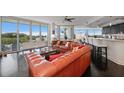 Inviting living room with expansive windows offering stunning waterfront views and plenty of natural light at 2 Seaside Ln # 203, Belleair, FL 33756