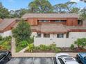 Aerial view showcasing the property's location, landscaping, and proximity to parking at 2078 Sunset Point Rd # 83, Clearwater, FL 33765