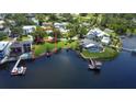 Aerial view of a waterfront property on a sunny day, with dock access at 2205 N Riverside Dr, Tampa, FL 33602