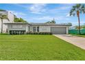 Charming home with well-maintained lawn, attached garage, and updated facade at 2205 N Riverside Dr, Tampa, FL 33602