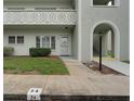 View of the exterior of Unit 24 featuring a walkway and a partial view of the apartment building at 2256 Philippine Dr # 24, Clearwater, FL 33763
