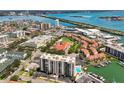 Waterfront condo complex featuring community pool and boat docks on a scenic coast at 255 Dolphin Pt # 207, Clearwater Beach, FL 33767